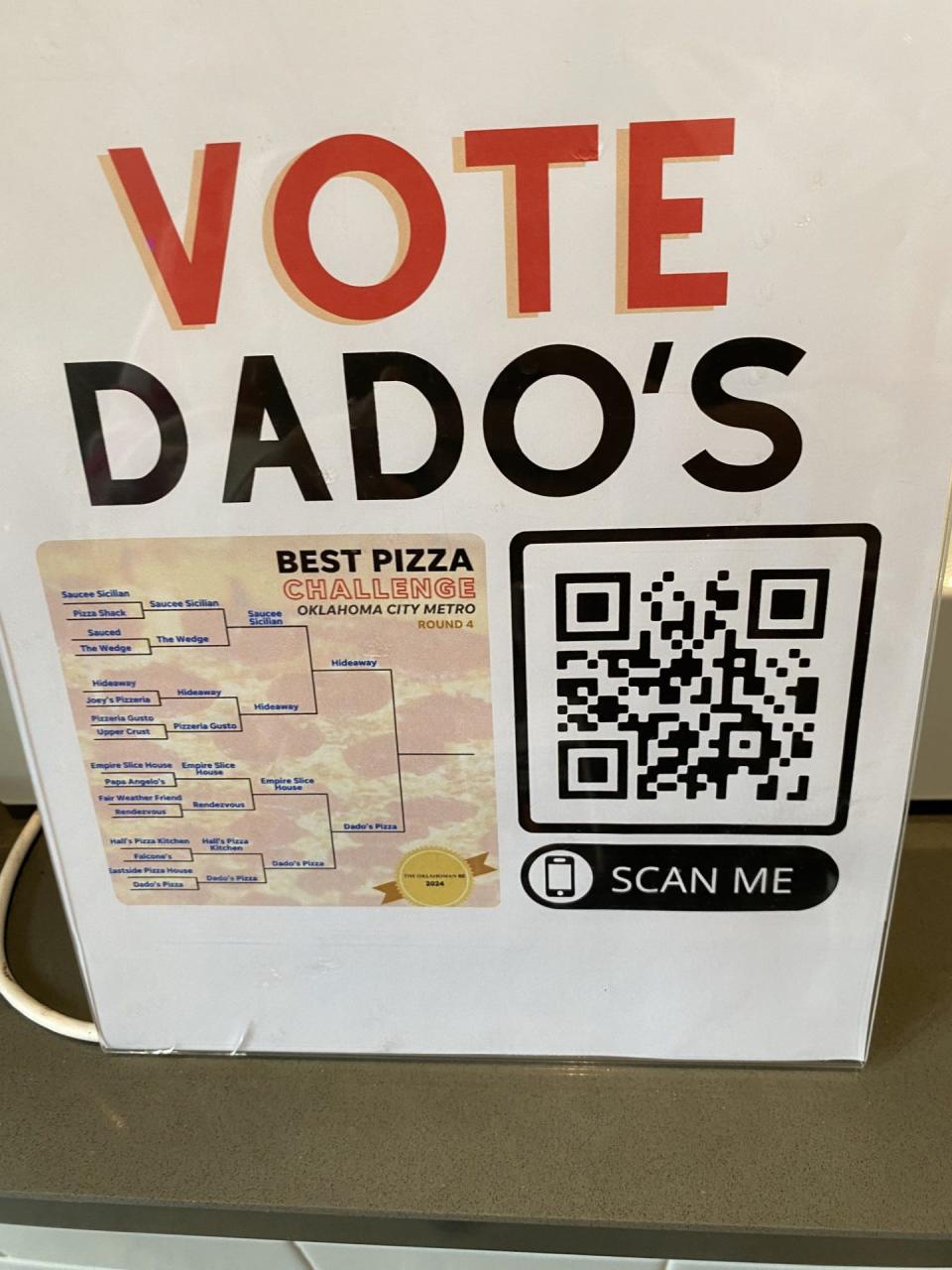 A sign at the register at Dado's pizza encouraging visitors to vote during the OKC Metro's Best Pizza Bracket.