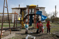 Afghan migrant children play in front of their homes in Kars, eastern Turkey, April 11, 2018. Picture taken April 11, 2018. REUTERS/Umit Bektas