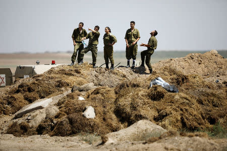 Israeli soldiers look over to the fence from the Israeli side of the border between Israel and Gaza during protest on the Gaza side June 8, 2018. REUTERS/Amir Cohen