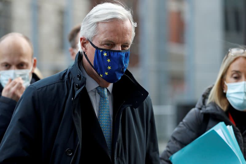 FILE PHOTO: European Union's chief Brexit negotiator Michel Barnier, wearing a face mask, leaves Brexit trade negotiations in London