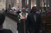 The Very Rev. Kris Stubna, left, waves to parishioners after Mass at St. Paul Catholic Cathedral in Pittsburgh on Sunday, June 26, 2022. During his service, Stubna said that Friday's Supreme Court ruling to overturn Roe v. Wade was, "a day of great joy and blessing." (AP Photo/Jessie Wardarski)