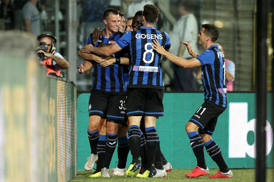 Atalanta's Hans Hateboer, left, celebrates with teammates after scoring his side's 2nd goal during the Serie A soccer match between Atalanta and Frosinone Calcio at the Atleti Azzurri d'Italia stadium in Bergamo, Italy, Monday, Aug. 20, 2018. (Paolo Magni/ANSA via AP)