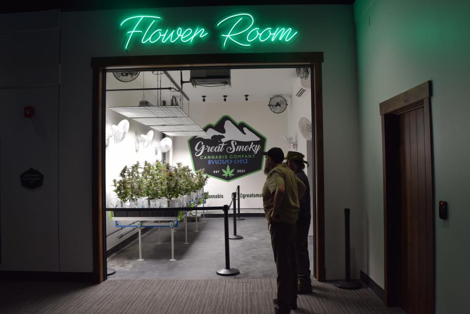Two people look at the cannabis "Flower Room" display at the Great Smoky Cannabis Co. dispensary on the Qualla Boundary in Cherokee, North Carolina April 20.