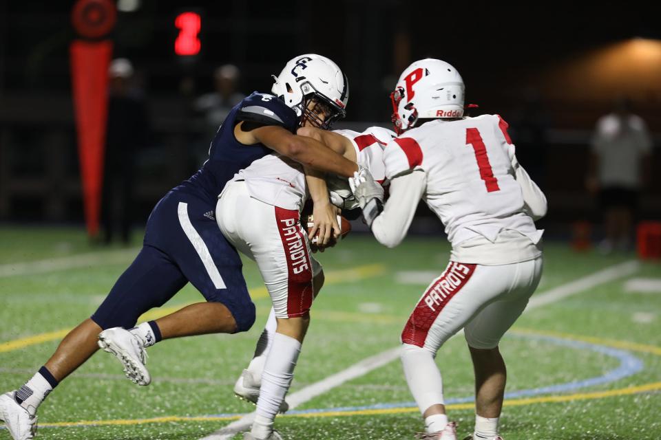 Gates Chili's Joseph Garcia sacks Penfield quarterback Adam Schembri while Penfield's Christopher McLean is too late to help out during the football game at Gates Chili on September 16, 2021. 