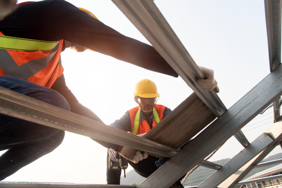 Construction Industry. Roofer with Ceramic Tiles in Hands. Roof Worker Closeup. House Rooftop Covering  Roof construction.