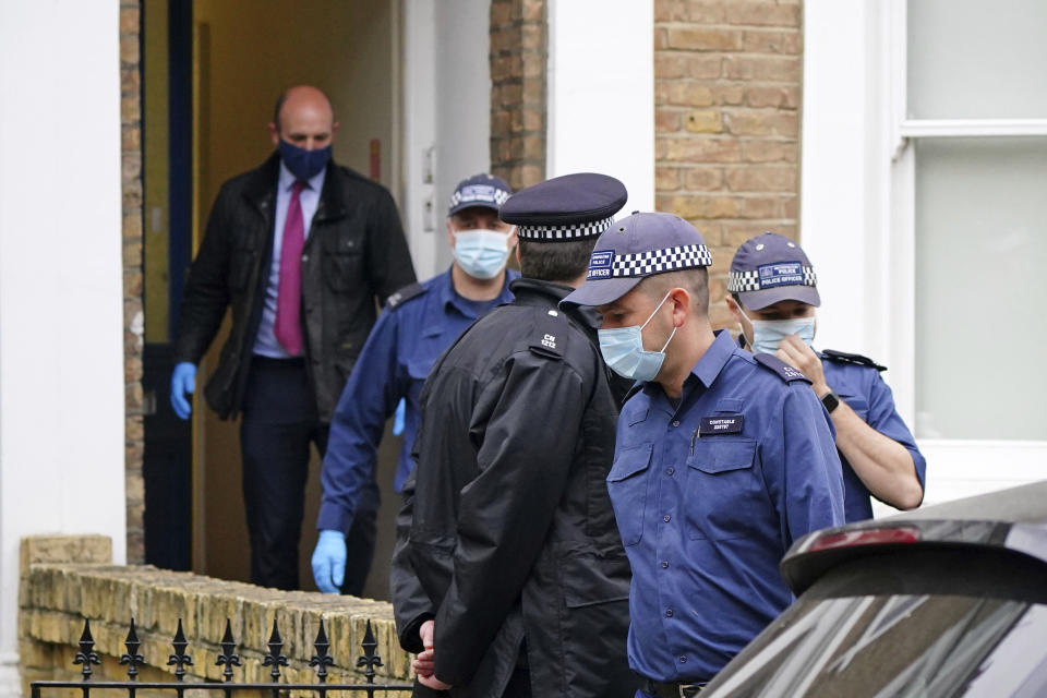 Police search a house believed to be in relation to the slaying of member of Parliament David Amess on Friday, in London, Sunday, Oct. 17, 2021. The slaying Friday in Leigh-on-Sea of the 69-year-old Conservative lawmaker Amess during his regular weekly meeting with local voters has caused shock and anxiety across Britain's political spectrum, just five years after Labour Party lawmaker Jo Cox was murdered by a far-right extremist in her small-town constituency. (Dominic Lipinski/PA via AP)