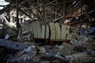 Burnt books are seen in a damaged workshop of Ukraine's largest printing house ruined in Thursday deadly Russian missile attack that killed seven civilians in Kharkiv, Ukraine, Friday, May 24, 2024. (Ukrainian Presidential Press Office via AP)