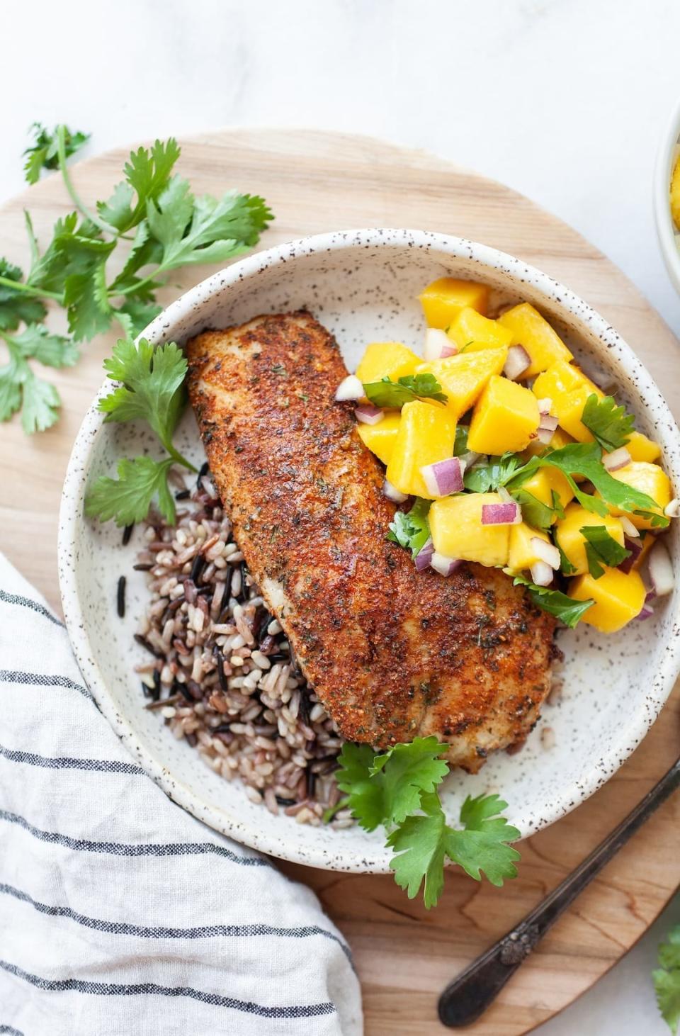 Blackened tilapia with mango salsa over wild rice.