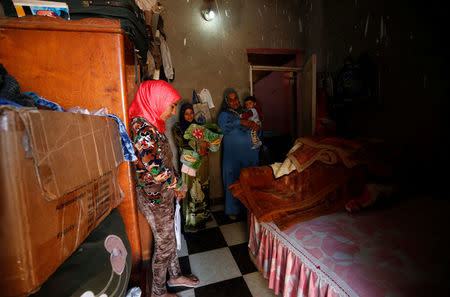 Amany Shamekh (L), 16, stands near her mother Zeinab (R) with Reem Mamdouh (C), 26, wife of Amany's brother at their home in Awlad Serag village of Assiut Governorate, south of Cairo, Egypt, February 8, 2018. REUTERS/Hayam Adel/Files