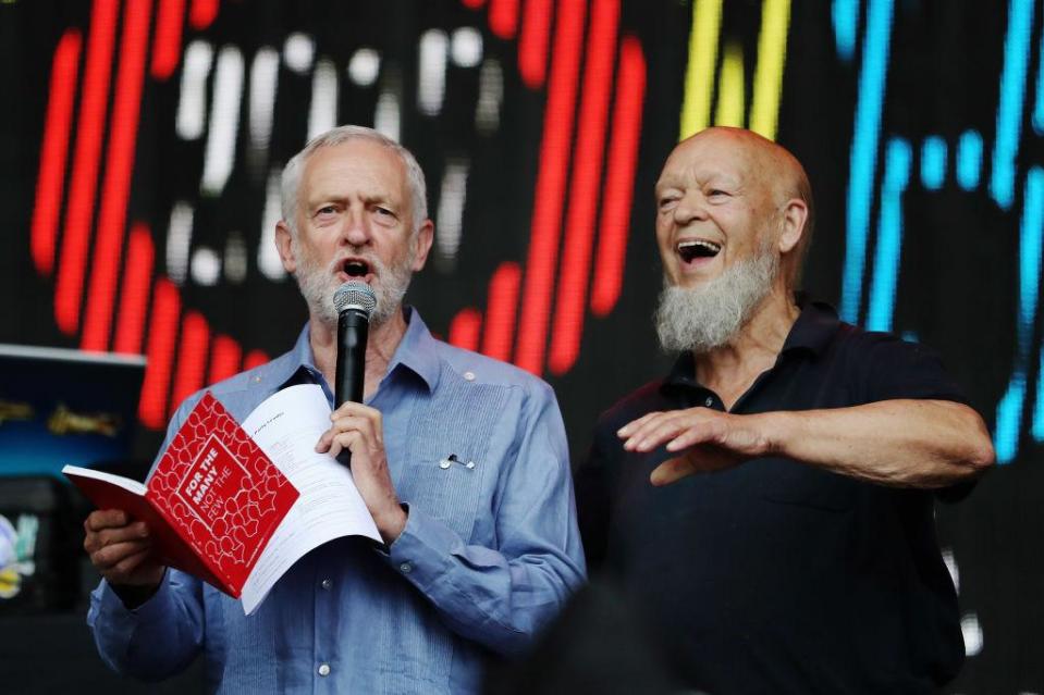 Labour party leader Jeremy Corbyn addresses the crowd alongside Glastonbury organiser Michael Eavis on the Pyramid Stage as he makes a guest appearance at the Glastonbury Festival Site, 24 June 2017 (Getty Images)