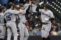 Miami Marlins' Avsail Garcia is congratulated after hitting a grand slam during the eighth inning of a baseball game against the Milwaukee Brewers Thursday, Sept. 29, 2022, in Milwaukee. (AP Photo/Morry Gash)