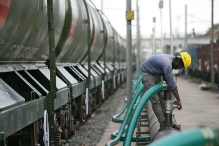 A technician checks a valve before water is pumped into a tanker train, which will be transported and supplied to drought-hit city of Chennai, at Jolarpettai railway station in the southern state of Tamil Nadu