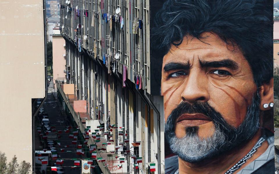 Naples is full of murals depicting its folk heroes, including this one of the footballer Diego Maradona - Marco Cantile/AP