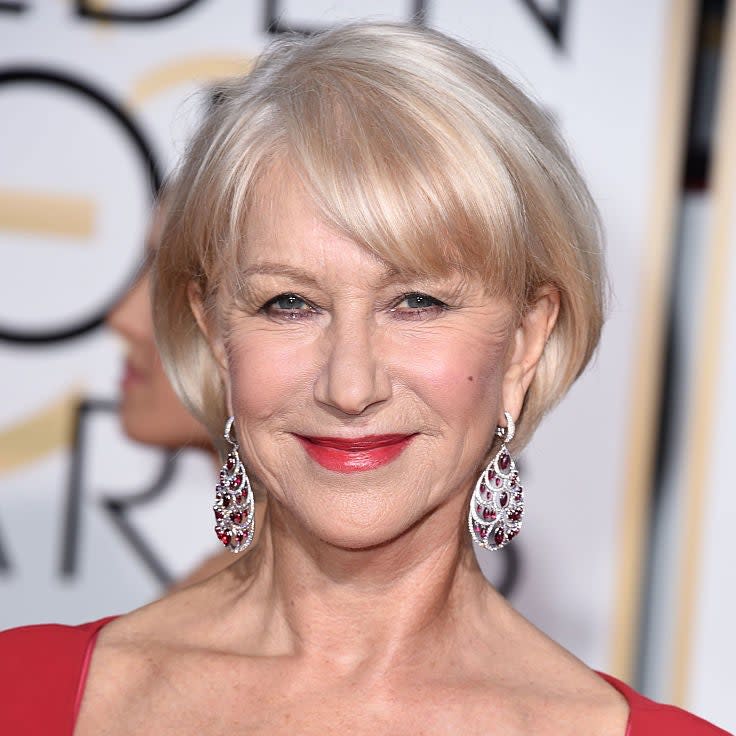 Helen Mirren on the red carpet wearing a sparkling embellished dress and drop earrings