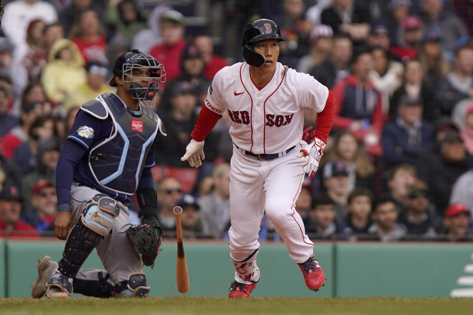 Boston Red Sox's Masataka Yoshida, right, runs to first after hitting an RBI-single as Tampa Bay Rays' Christian Bethancourt, left, looks on in the third inning of a baseball game, Sunday, June 4, 2023, in Boston. (AP Photo/Steven Senne)
