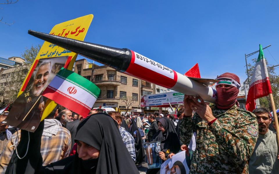 Iranians attend the funeral procession for seven Islamic Revolutionary Guard Corps members killed in a strike in Syria, which Iran blamed on Israel