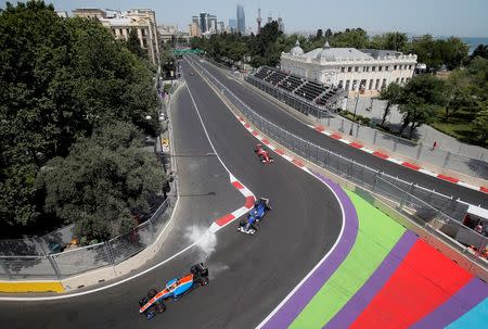 Formula One - Grand Prix of Europe - Baku, Azerbaijan - 18/6/16 - Manor Racing F1 driver Rio Haryanto of Indonesia, Sauber F1 driver Marcus Ericsson of Sweden and Ferrari F1 driver Sebastian Vettel of Germany drive during the third practice session. REUTERS/Maxim Shemetov