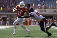 Texas quarterback Casey Thompson (11) tries to run past Texas Tech linebacker Jesiah Pierre (16) during the first half of an NCAA college football game on Saturday, Sept. 25, 2021, in Austin, Texas. (AP Photo/Chuck Burton)