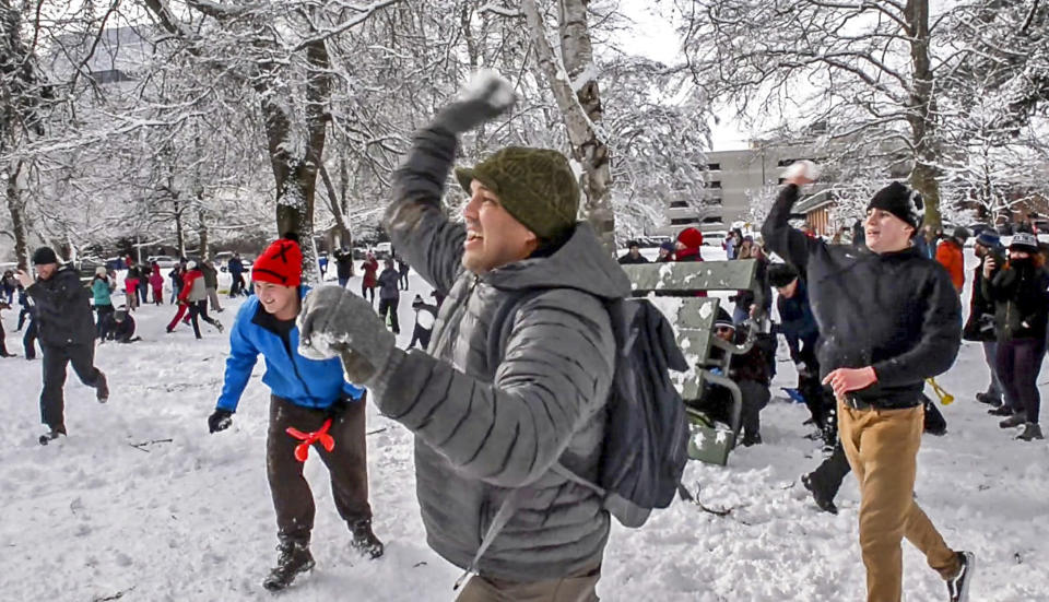 People participate in a snowball fight at Wright Park, Sunday, Feb. 10, 2019, in Tacoma, Wash. Pacific Northwest residents who are more accustomed to rain than snow were digging out from a winter storm and bracing for more on Sunday. (Peter Haley/The News Tribune via AP)