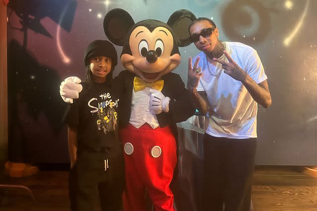 <p>courtesy Tyga</p> Tyga and his son King Cairo enjoyed a day at Disneyland with Mickey Mouse on Sept. 2.