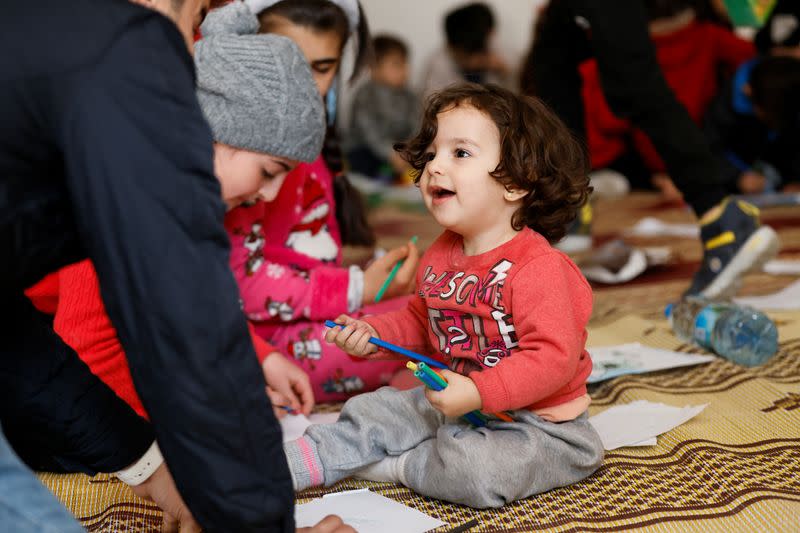 Children play at a makeshift shelter in Mersin