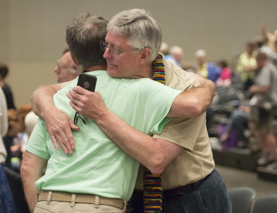 FILE - In this June 19, 2014, file photo, Gary Lyon, left, and Bill Samford celebrate after a vote allowing Presbyterian pastors discretion in marrying same-sex couples at the 221st General Assembly of the Presbyterian Church at Cobo Hall, in Detroit. When the United Methodist Church removed anti-LGBTQ language from its official rules in recent days, it marked the end of a half-century of debates over LGBTQ inclusion in mainline Protestant denominations. The moves sparked joy from progressive delegates, but the UMC faces many of the same challenges as Lutheran, Presbyterian and Episcopal denominations that took similar routes, from schisms to friction with international churches to the long-term aging and shrinking of their memberships. (David Guralnick/Detroit News via AP, file)