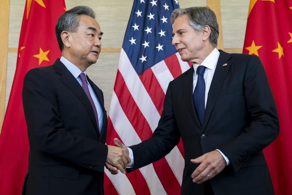 FILE - U.S. Secretary of State Antony Blinken, right, shakes hands with China's Foreign Minister Wang Yi during a meeting in Nusa Dua on the Indonesian resort island of Bali on July 9, 2022. In his comments at a security conference in Munich, Germany, Blinken said the United States has long been concerned that China would provide weapons to Russia and that “we have information that gives us concern that they are considering providing lethal support to Russia in the war against Ukraine.” That came a day after Blinken held talks with Wang in a meeting that offered little sign of a reduction in tensions or progress on the Ukraine issue. (Stefani Reynolds/Pool Photo via AP, File)