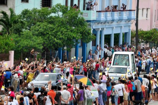 Cubans wave to Pope Benedict XVI as he leaves in his Popemobile in Havana. Pope Benedict XVI on Wednesday wrapped up a visit to Cuba with a call for respect of "basic freedoms," pursuing his persistent prodding of the island's Communist authorities to embrace change