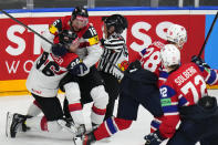 Austria's Mario Huber, left, celebrates with Austria's Dominic Zwerger, 2nd left, after scoring his sides fourth goal during the preliminary round match between Norway and Austria at the Ice Hockey World Championships in Prague, Czech Republic, Sunday, May 19, 2024. (AP Photo/Petr David Josek)