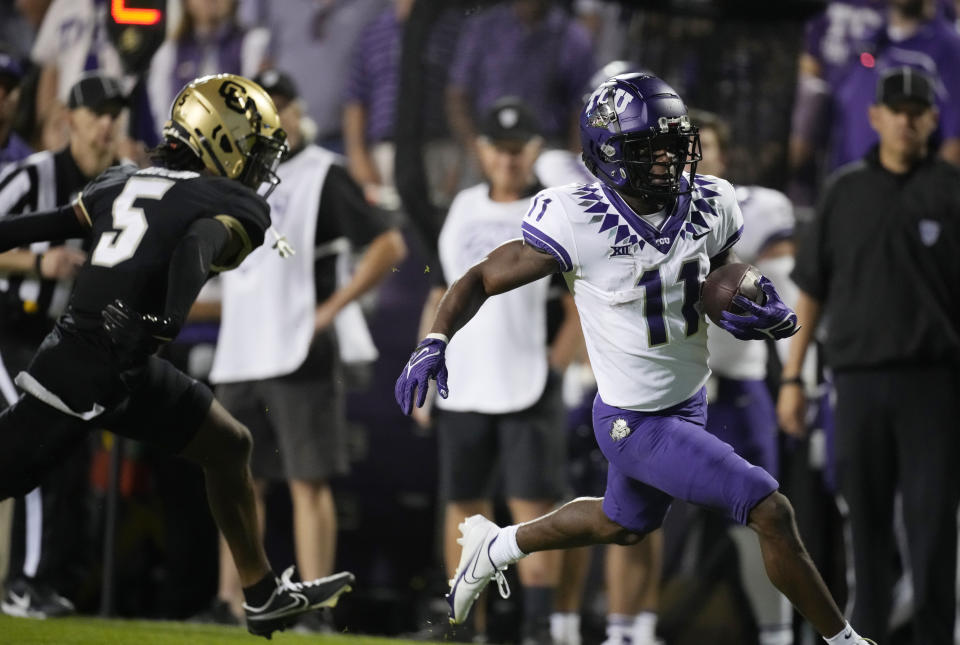 TCU wide receiver Derius Davis, right, runs for a touchdown after catching a pass with Colorado safety Tyrin Taylor in pursuit in the second half of an NCAA college football game Friday, Sept. 2, 2022, in Boulder, Colo. (AP Photo/David Zalubowski)