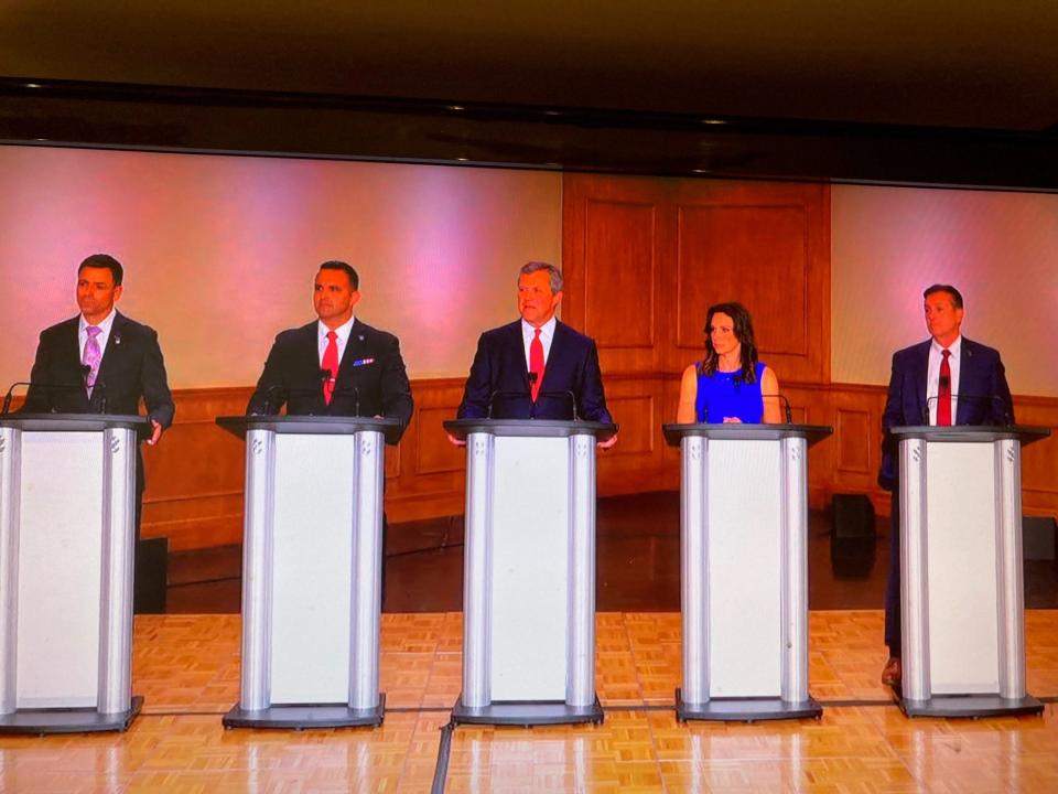 From left, Republican gubernatorial candidates Ryan Kelley, Garrett Soldano, Kevin Rinke, Tudor Dixon and Ralph Rebandt on the debate state at Oakland University Wednesday.