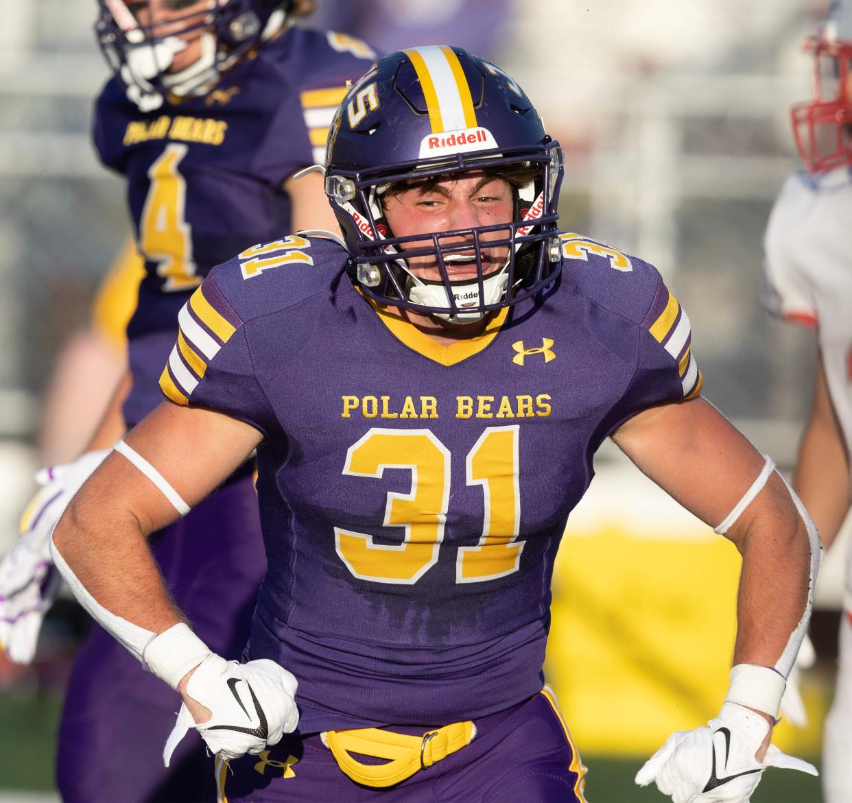 Jackson's Jordan Warmath celebrates stopping the Mentor run at the goal line in the first quarter at home Friday, August 18, 2023.