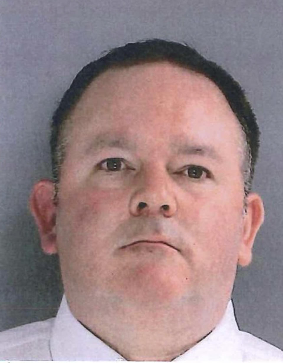 In this photo provided by the Delaware County District Attorney's Office on Tuesday, Jan. 18, 2022, shows Sharon Hill Police officer Brian Devaney. Devaney is one of three police officers that have been charged with manslaughter and reckless endangerment after firing their weapons into a crowd of people exiting a high school football game outside of Philadelphia, killing 8-year-old Fanta Bility and injuring three people. (Delaware County District Attorney's Office vis AP)