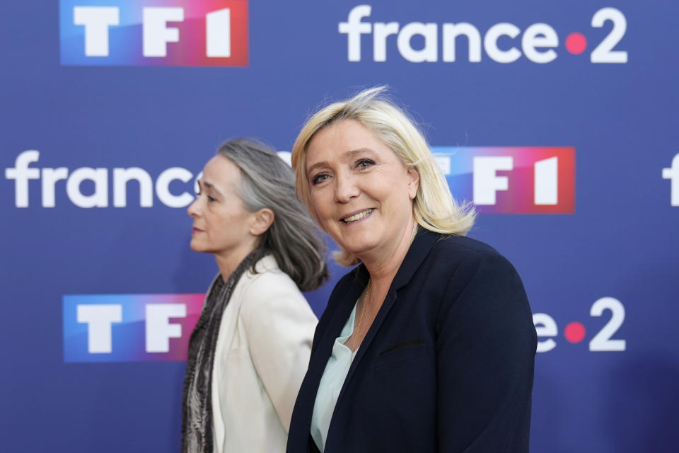 French far-right leader Marine Le Pen arrives at a television recording studio for a debate with centrist candidate and French President Emmanuel Macron, Wednesday, April 20, 2022 in La Plaine-Saint-Denis, outside Paris. In the climax of France's presidential campaign, centrist President Emmanuel Macron and far-right contender Marine Le Pen meet in a one-on-one television debate that could prove decisive before Sunday's runoff vote. Behind is chief executive officer of French TV Group France Televisions Delphine Ernotte. (AP Photo/Francois Mori)