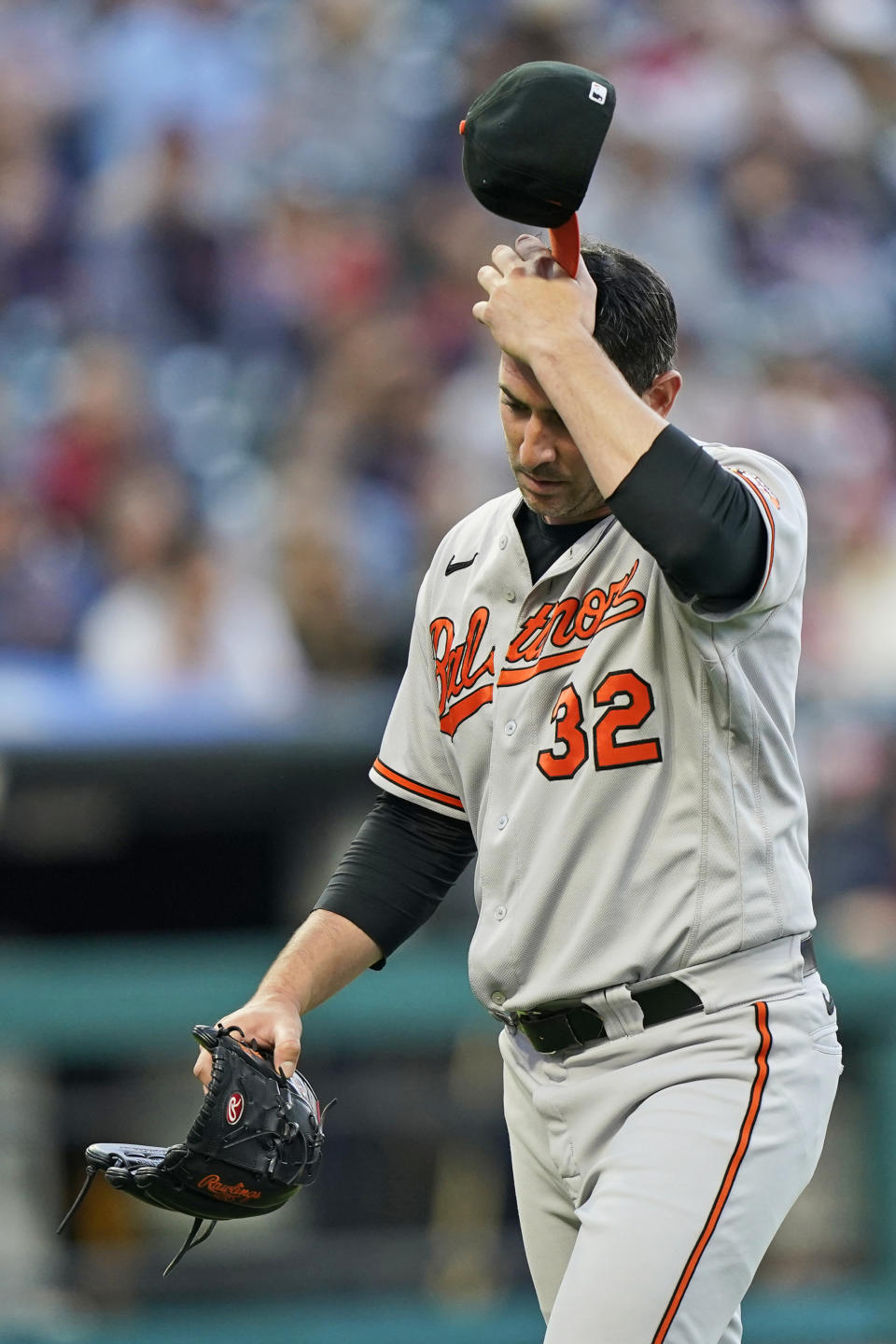 Baltimore Orioles starting pitcher Matt Harvey walks to the dugout in the fourth inning of a baseball game against the Cleveland Indians, Tuesday, June 15, 2021, in Cleveland. Harvey pitched 3 1/3 innings and gave up six hits and six runs. (AP Photo/Tony Dejak)