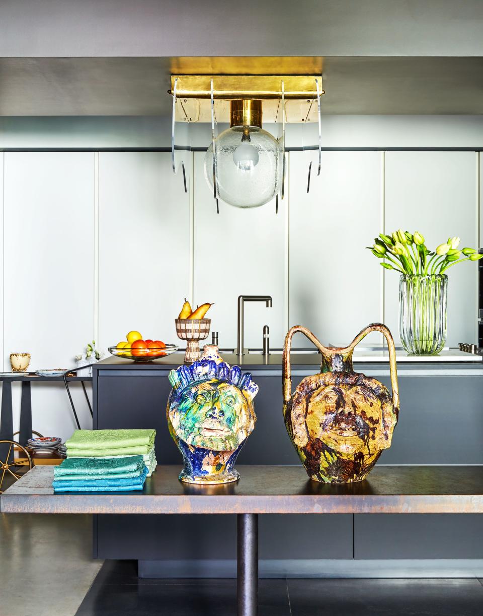 A 1970s light fixture hangs in the kitchen. Sicilian ceramic vases.