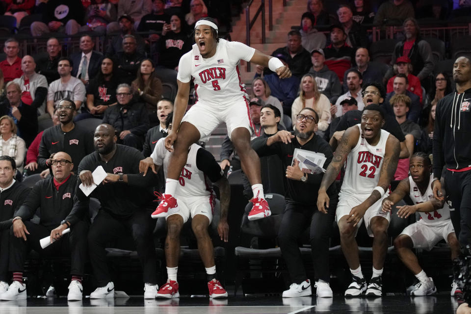 UNLV forward Rob Whaley Jr. (5) celebrates from the bench as UNLV scores against Creighton during the second half of an NCAA college basketball game Wednesday, Dec. 13, 2023, in Henderson, Nev. (AP Photo/John Locher)