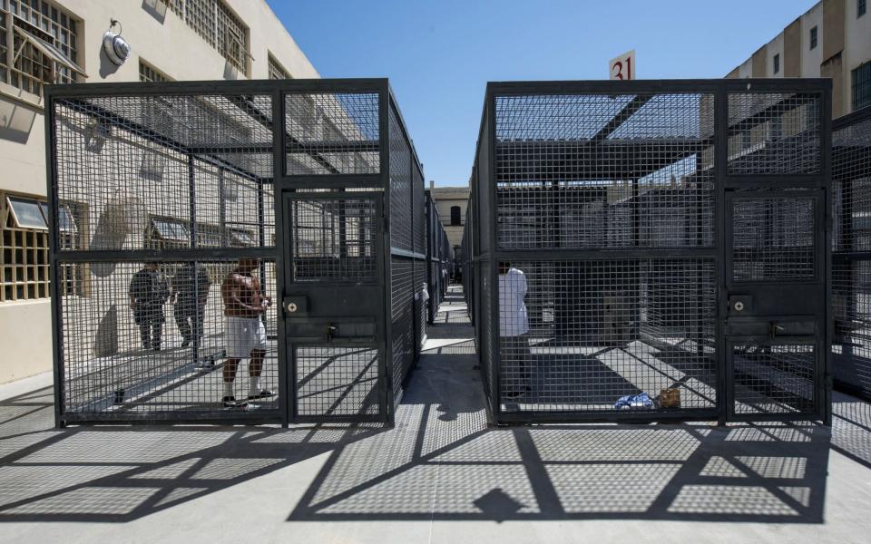 Inmates exercise in cages at San Quentin State Prison in San Quentin, California, U.S., on Tuesday, Aug. 16, 2016. San Quentin, home to t
