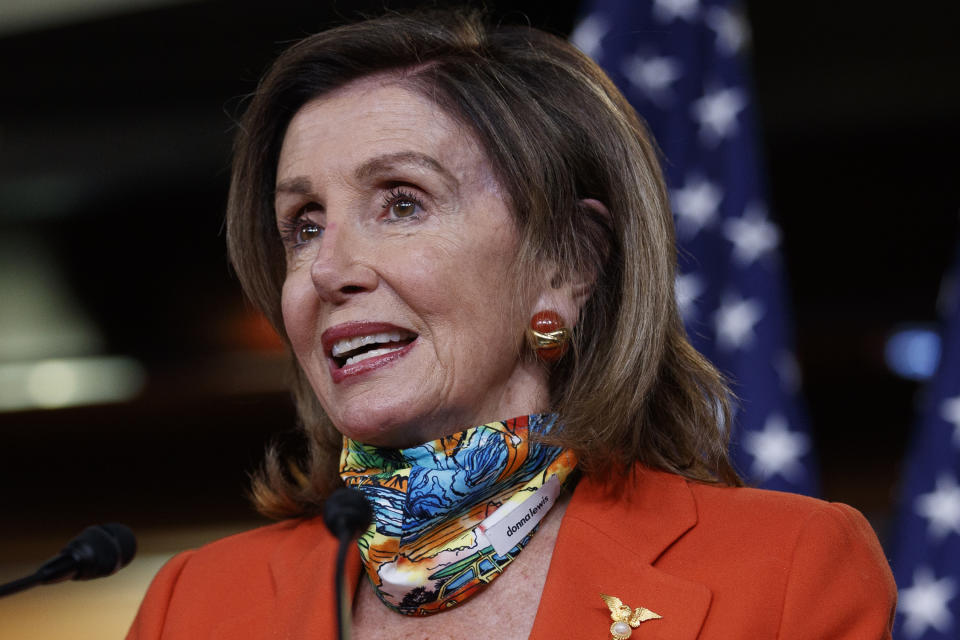 FILE - In this June 26, 2020, file photo, House Speaker Nancy Pelosi of Calif., speaks at a news conference on Capitol Hill in Washington. After Pelosi began wearing masks that matched her outfits, people watching her on TV noticed they had a small donna lewis label on them. The boutique in Alexandria, Va., became besieged by purchase orders and soon ran out of the labels, which tend-conscious customers demanded. (AP Photo/Carolyn Kaster, File)