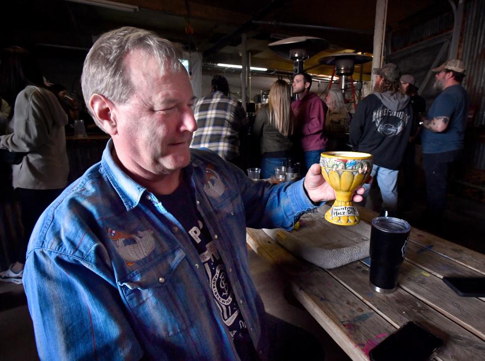 David McCain holds his Monty Python and the Holy Grail mug as he sips a Pappy's brew.