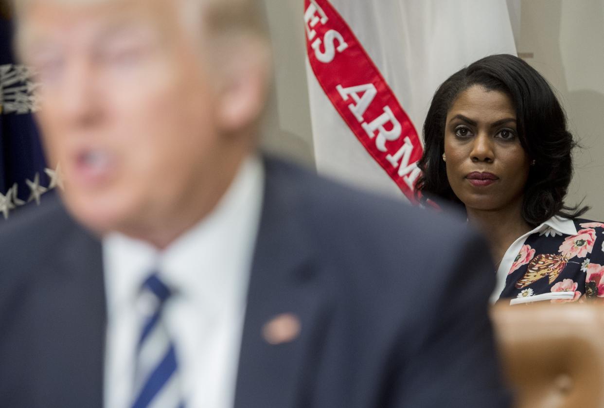 Omarosa Manigault (R), White House Director of Communications for the Office of Public Liaison, sits behind US President Donald Trump as he speaks during a meeting with teachers, school administrators and parents in the Roosevelt Room of the White House in Washington, DC, February 14, 2017 (AFP via Getty Images)