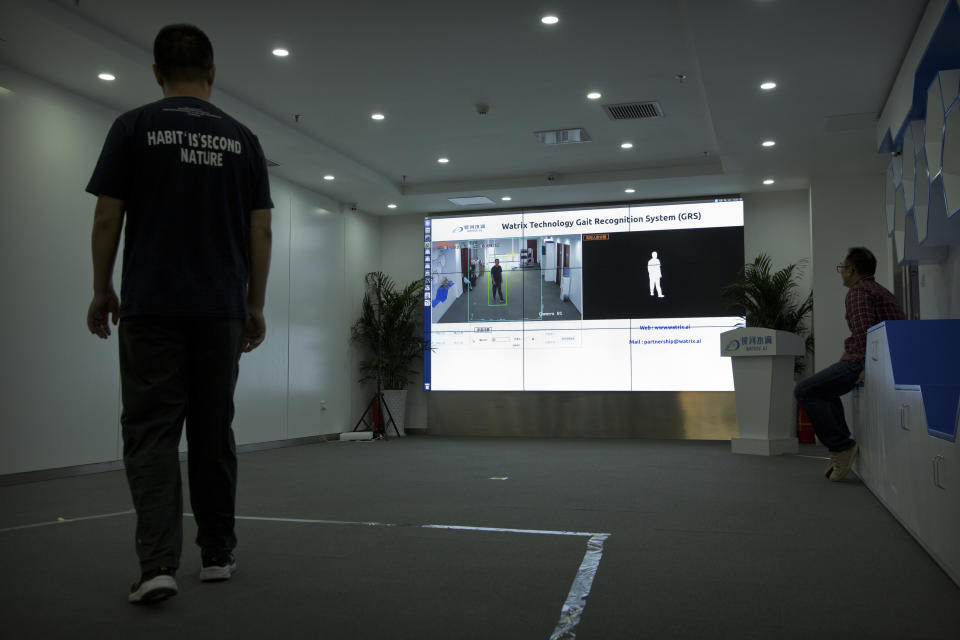 In this Oct. 31, 2018, photo, a Watrix employee walks around to enable their firm's gait recognition software to recognize his stride during a demonstration at their company's offices in Beijing. A Chinese technology startup hopes to begin selling software that recognizes people by their body shape and how they walk, enabling identification when faces are hidden from cameras. Already used by police on the streets of Beijing and Shanghai, “gait recognition” is part of a major push to develop artificial-intelligence and data-driven surveillance across China, raising concern about how far the technology will go. (AP Photo/Mark Schiefelbein)