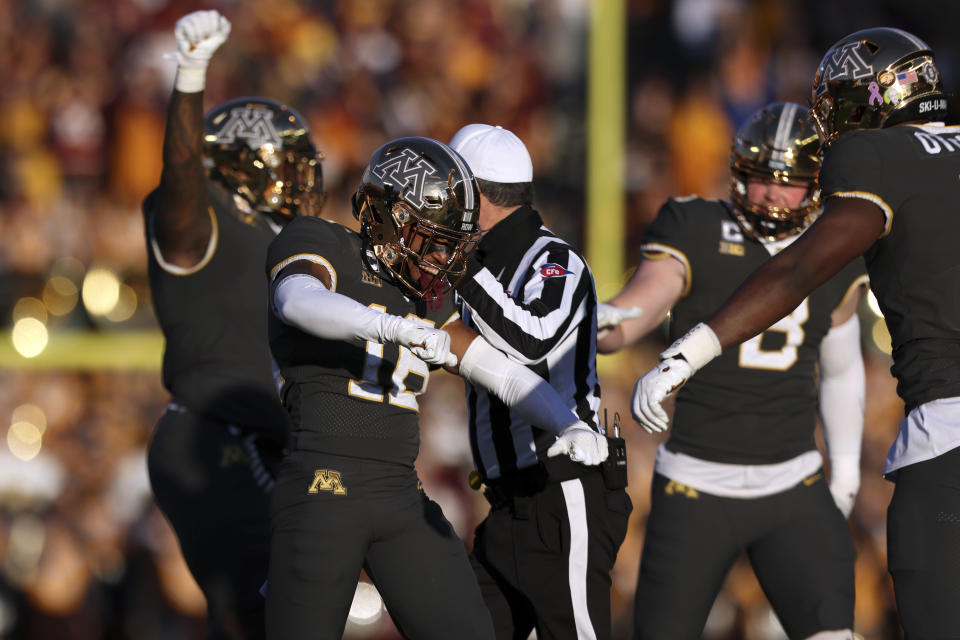 Minnesota defensive back Coney Durr (16) celebrates with teammates after stopping a Maryland play during the second half of an NCAA college football game Saturday, Oct. 23, 2021, in Minneapolis. (AP Photo/Stacy Bengs)