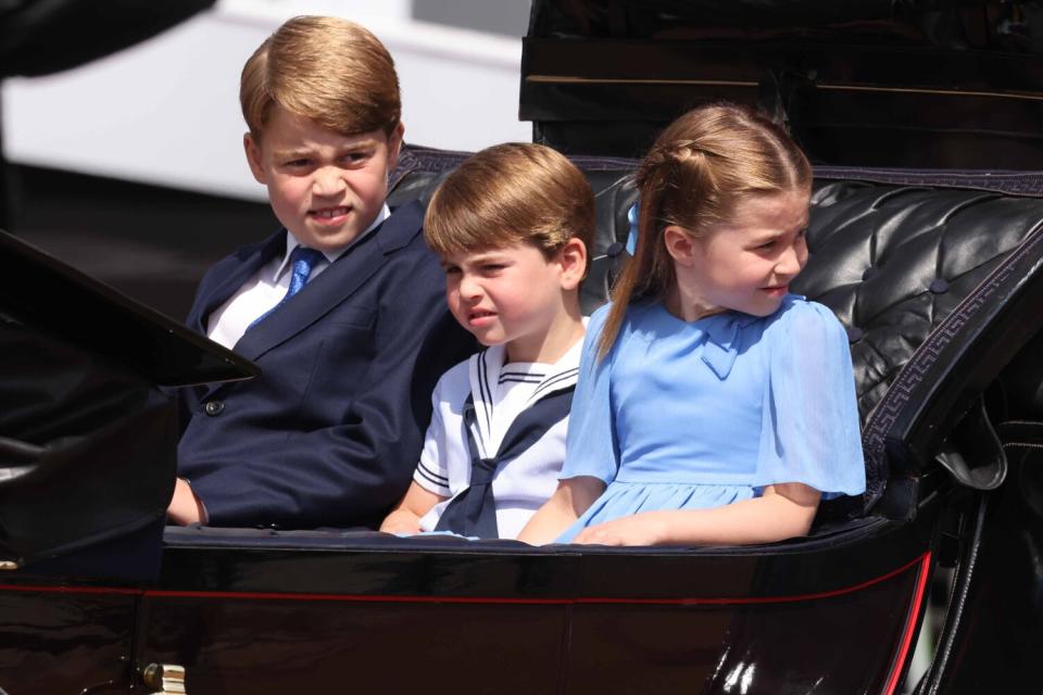 Prince George of Cambridge, Prince Louis of Cambridge and Princess Charlotte of Cambridge travel in a horse-drawn carriage during Trooping The Colour