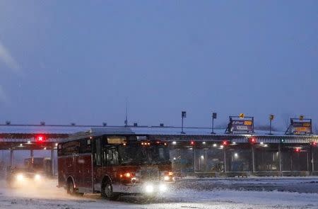 An emergency service vehicle exits the New York State Thruway, which was closed following a major traffic incident due to blizzard-like conditions, near Buffalo, New York, U.S., January 2, 2018. REUTERS/Brendan McDermid