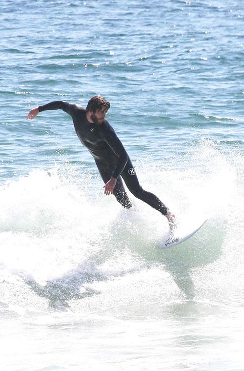 Liam Hemsworth bares all before a day in the surf