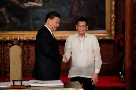 China's President Xi Jinping and Philippine President Rodrigo Duterte shake hands after a book signing at the Malacanang presidential palace in Manila, Philippines, November 20, 2018. Mark Cristino/Pool via Reuters