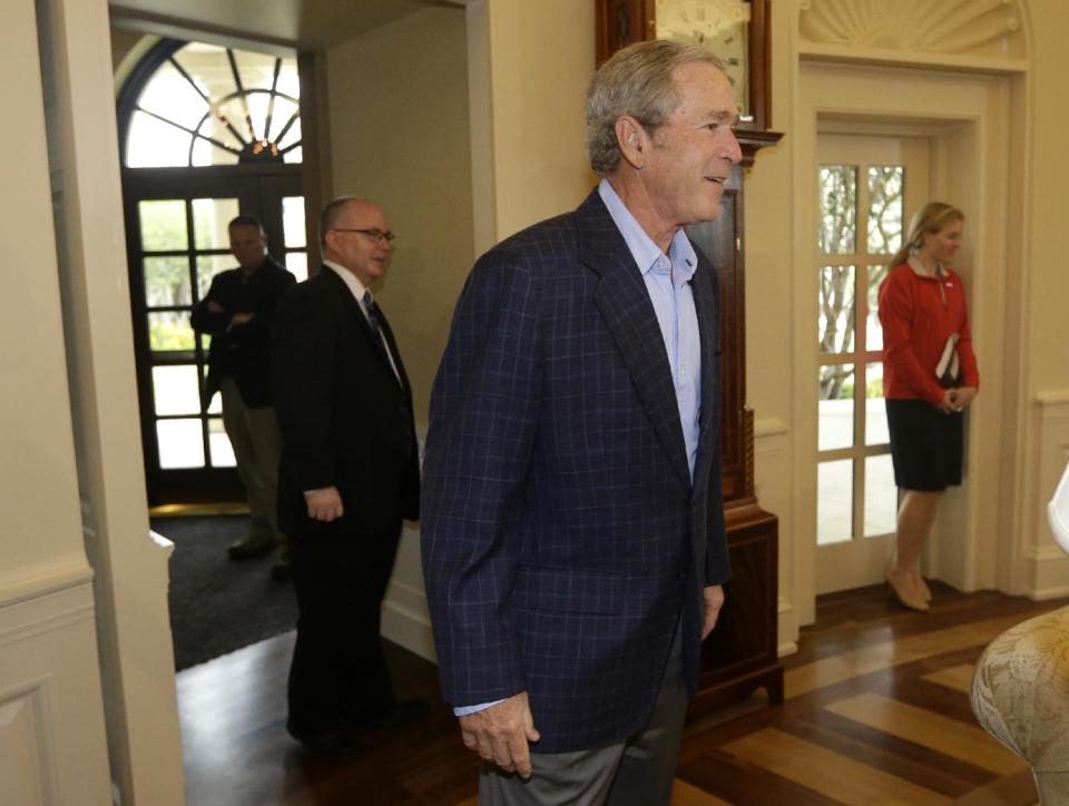 Former President George W. Bush walks into the oval office replica at the Bush Presidential Library as he surprises 43 Dallas-Fort Worth school children who were the first official guest of the museum on its' opening day Wednesday, May 1, 2013, in Dallas. (AP Photo/Tony Gutierrez)