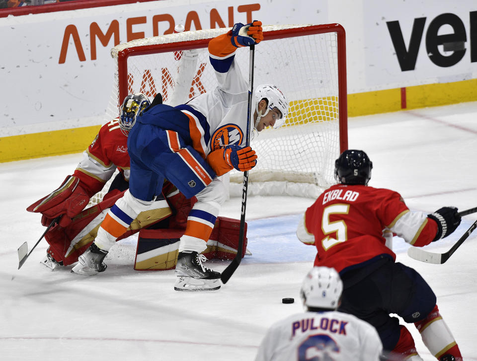 New York Islanders left wing Pierre Engvall (18) tries to score while standing in front of Florida Panthers goaltender Anthony Stolarz during the second period of an NHL hockey game, Saturday, Dec. 2, 2023, in Sunrise, Fla. (AP Photo/Michael Laughlin)