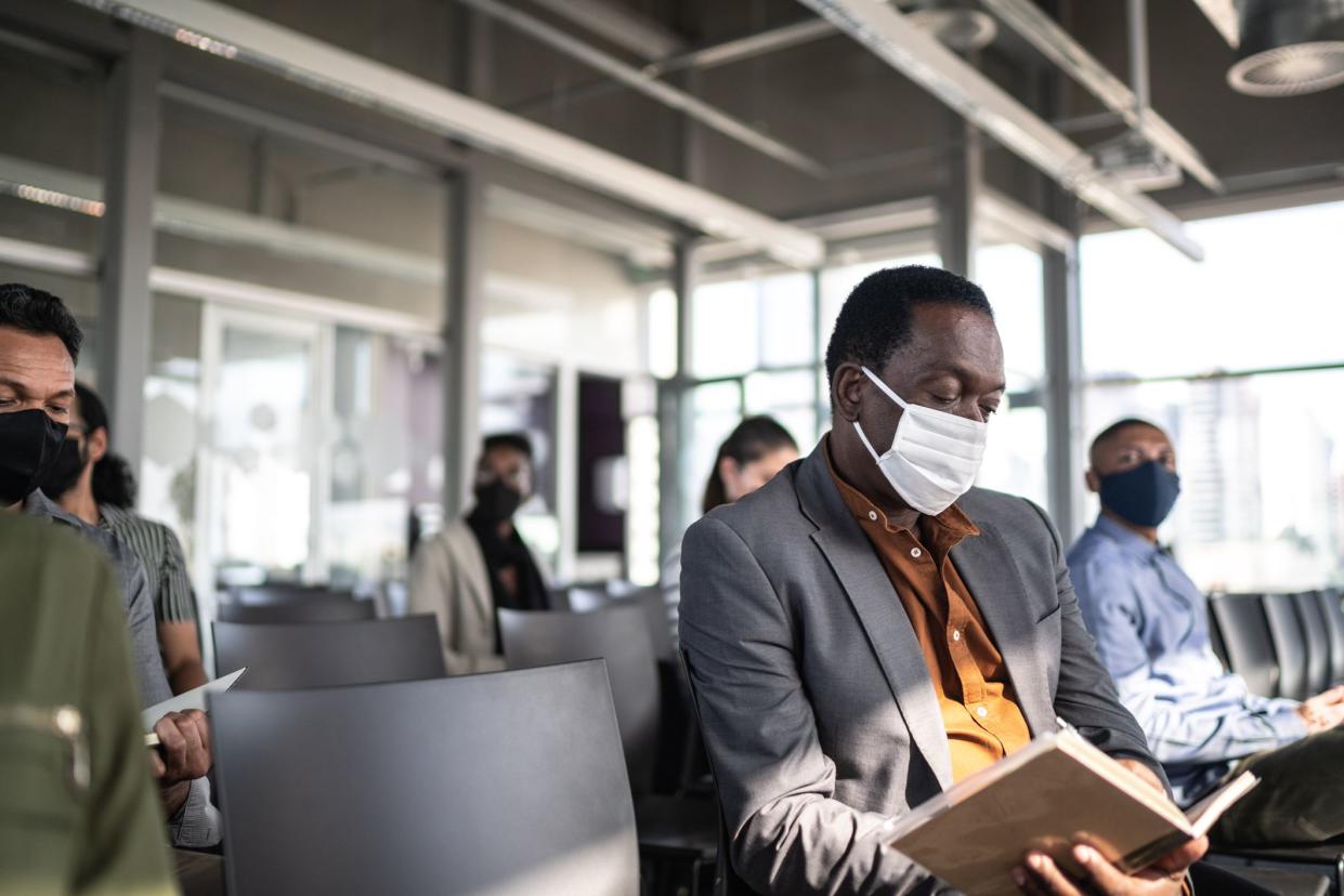 Business people attending a seminar with social distancing and face mask